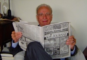 Media tycoon Rupert Murdoch reads a copy of the Marshall Islands Journal in Sydney, Australia. Photo: Karen Earnshaw