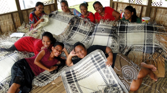 Weavers in the weaving house at the back of USP's campus. Photo: Karen Earnshaw