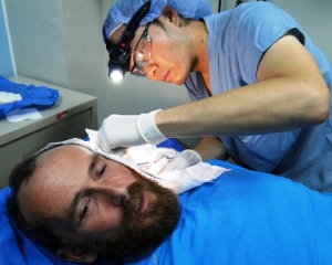Canvasback's Dr. John Kim does emergency surgery on a cruiser at Majuro Hospital.
