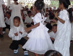 A group of children dancing at a church in Uliga. Photo: Giff Johnson