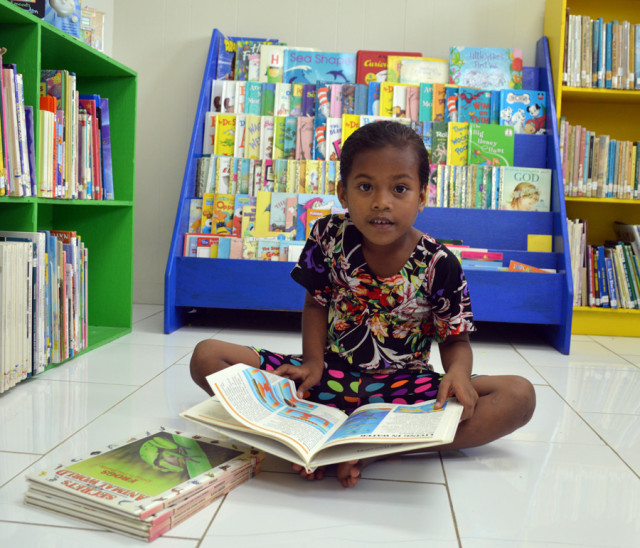 A young girl was spotted looking at a selection of books in the children's section of the Alele Library. Photo: Karen Earnshaw