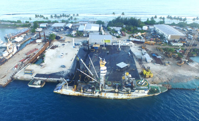 A purse seiner at the PII dock gets repairs made to its fishing net. Photo: PII