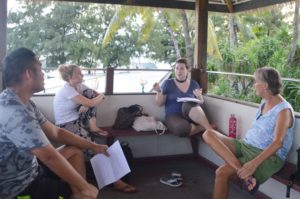 Amy critiques one of the stories with Jerry, Emily, and Lise of the Majuro Lagoon Writers. Photo: Karen Earnshaw