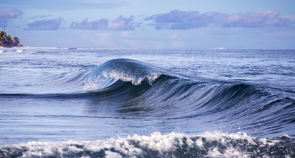 A curling wave taken from the pier at Majuro Bridge. Photo: Jamison Logan.