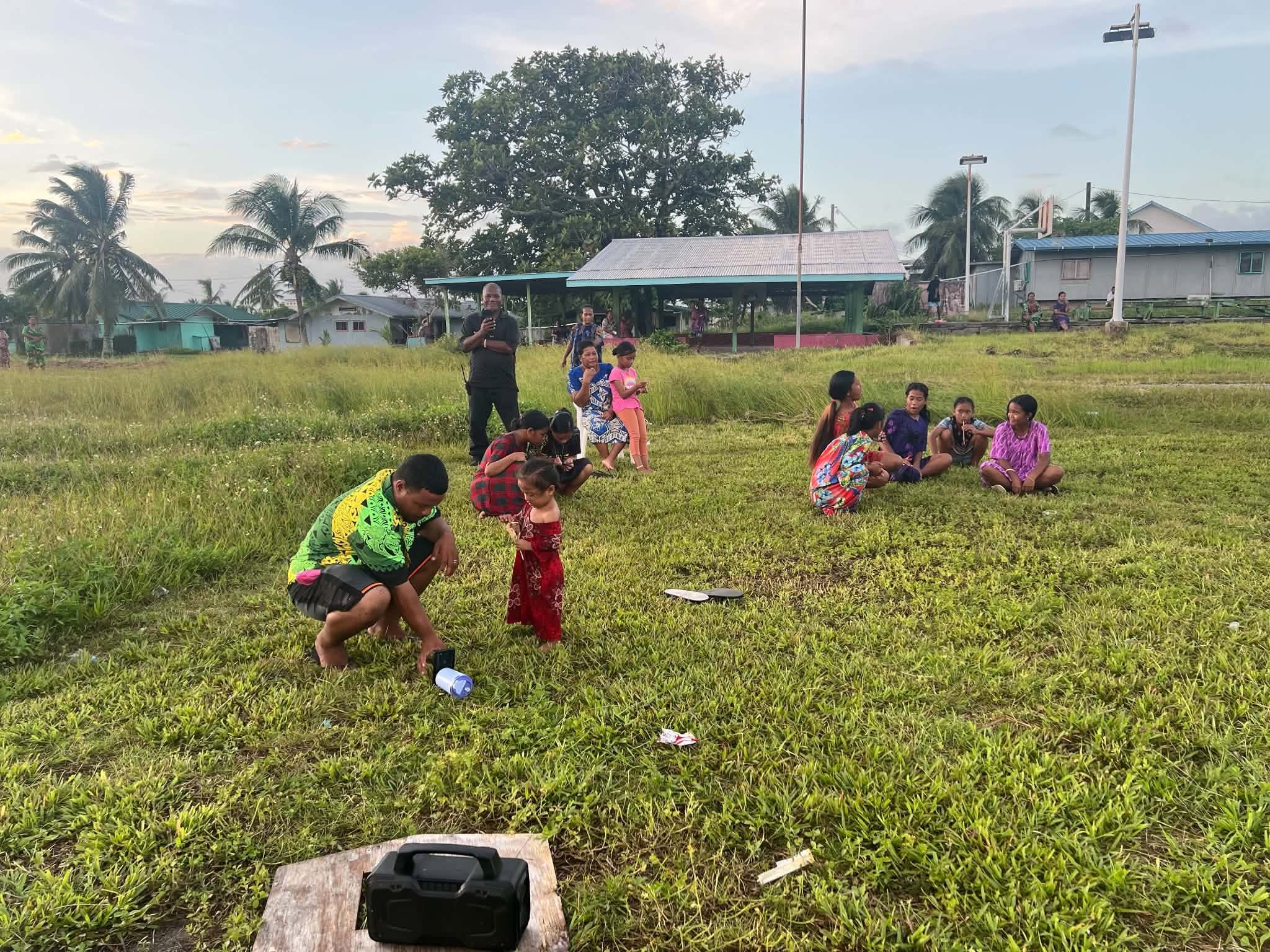 Kili Island, Christmas 2025 — a group gathers outdoors in the evening