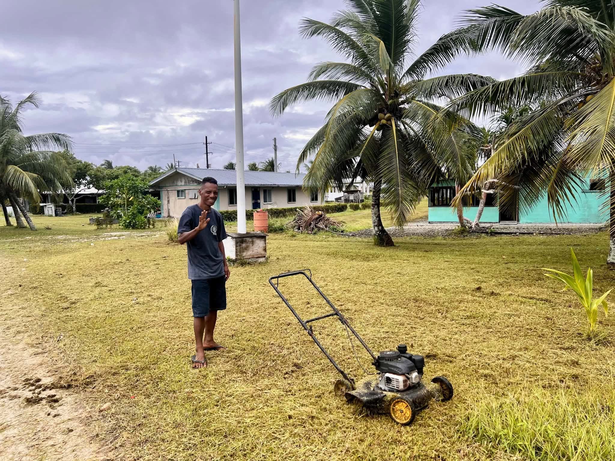 Kili Island, Christmas 2025 — a man mowing grass