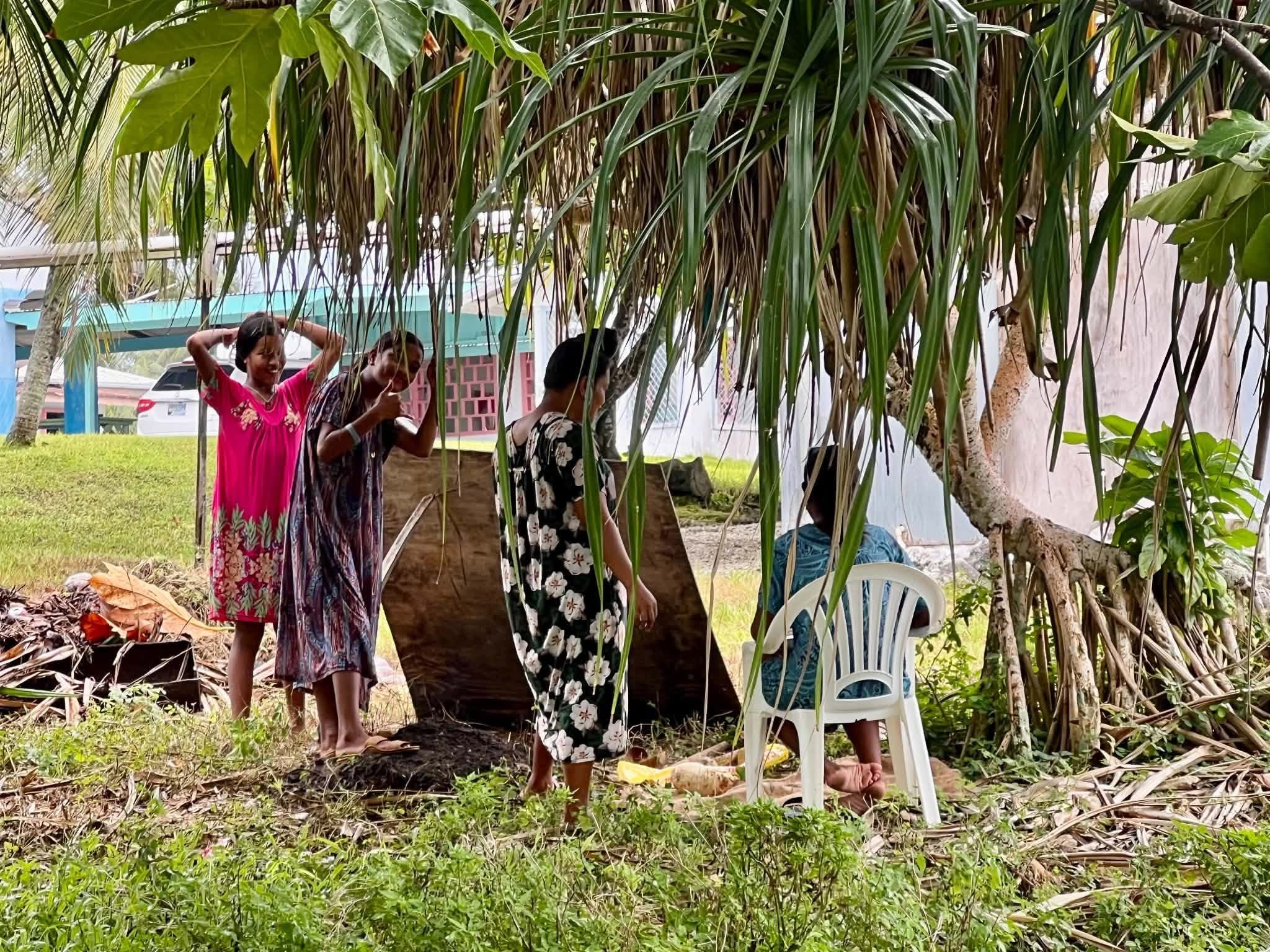 Kili Island, Christmas 2025 — four girls sitting under a pandanus tree