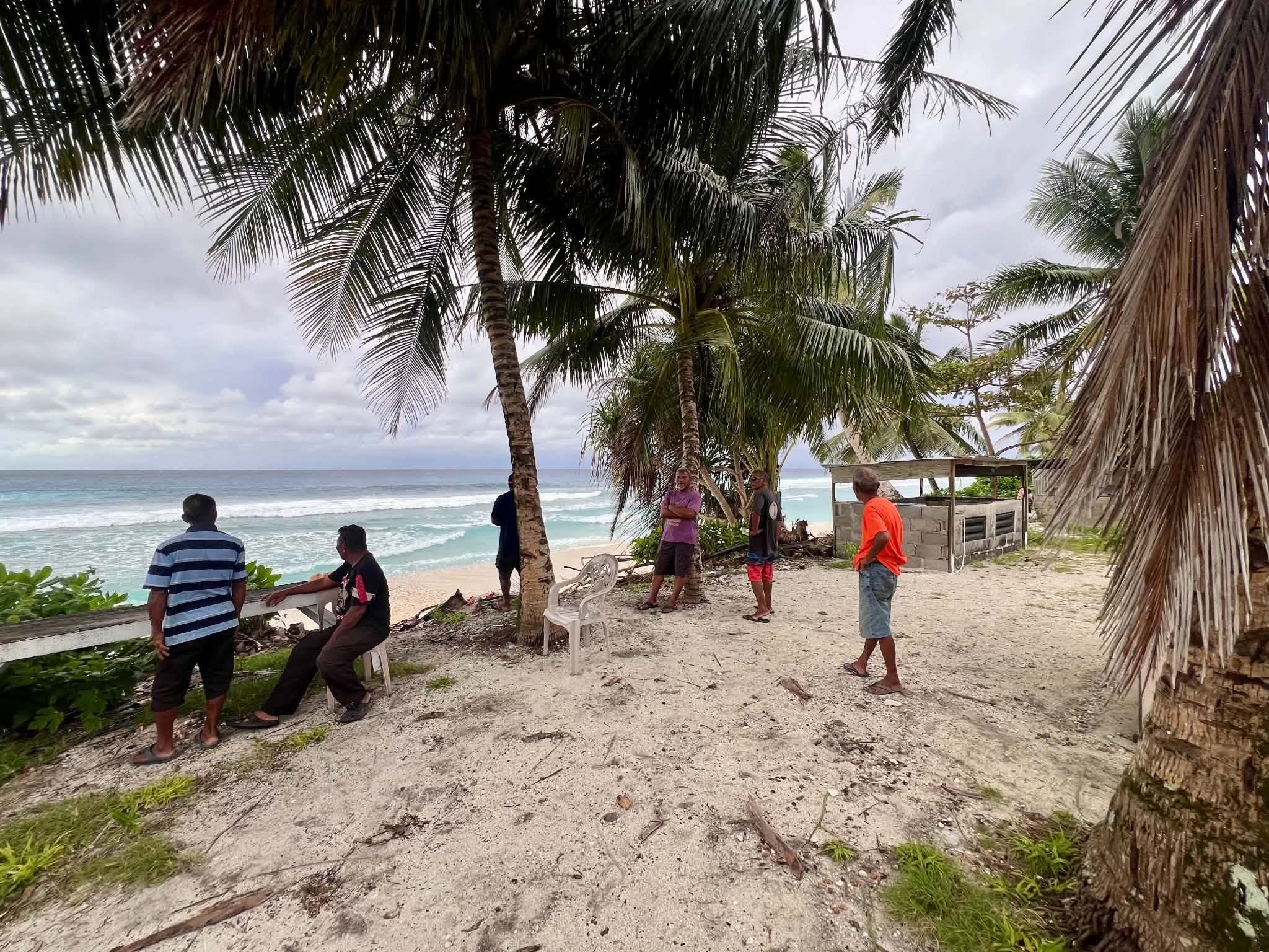 Kili Island, Christmas 2025 — a group of men under palm trees overlooking the ocean