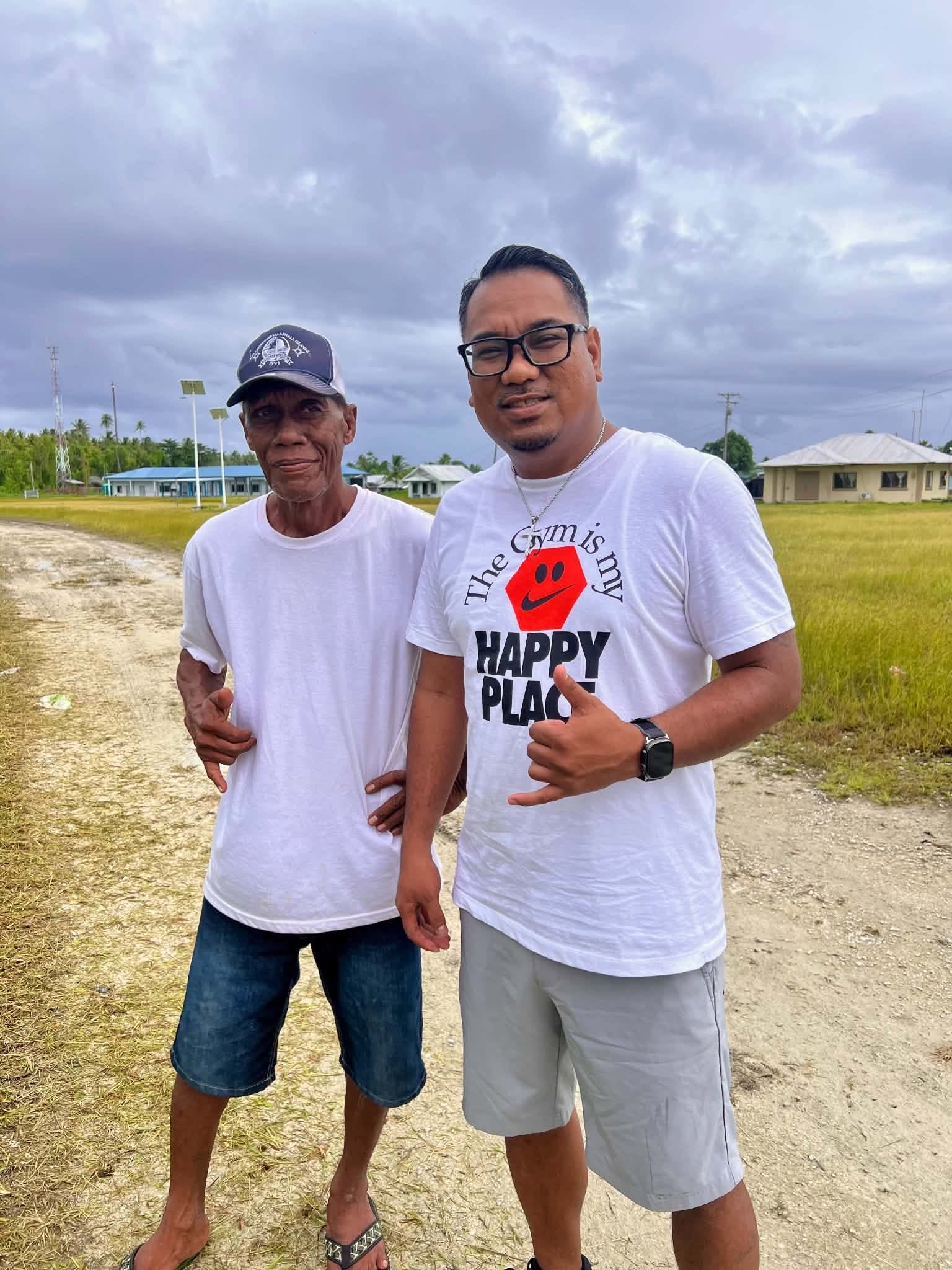 Kili Island, Christmas 2025 — two men standing arm in arm on a dirt road