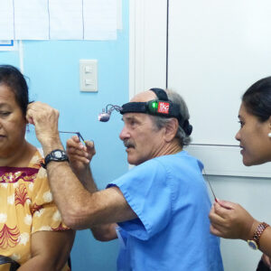 A Canvasback Missions doctor checks a patient's ear.