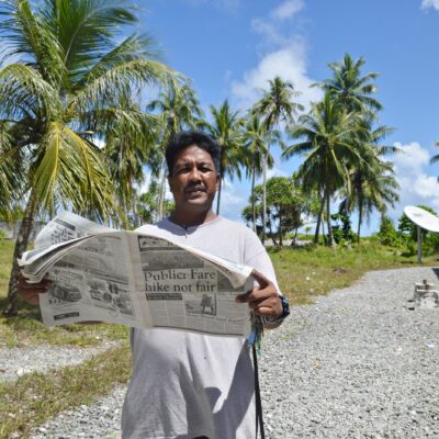 Airok Elementary School's head teacher Wilmen Mook reading the Marshall Islands Journal. Photo: Karen Earnshaw.
