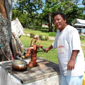 Cleveland Maie pumps water at his house on Likiep. Photo Karen Earnshaw