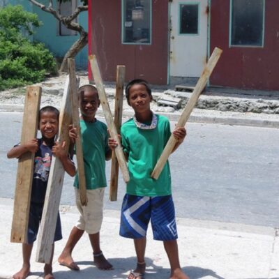 Three young boys pose for the camera on Ebeye. Photo: Westward II