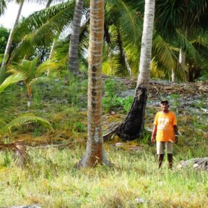 Likiep's Joe deBrum stands next to what is supposed to be the tallest spot of land in RMI. Photo Karen Earnshaw