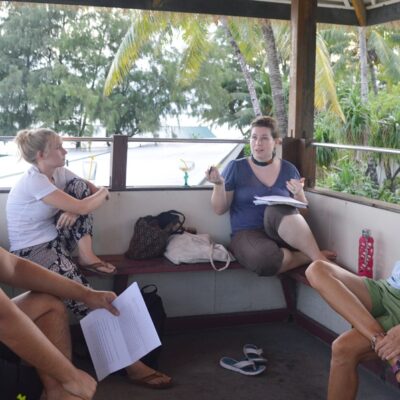 Amy critiques one of the stories with Jerry, Emily, and Lise of the Majuro Lagoon Writers. Photo: Karen Earnshaw
