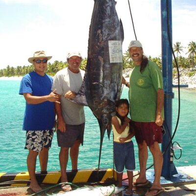 Pictured at a fishing tournament staged at Rongelap atoll in the early 2000s are Mayor James Matayoshi, champion fisherman Leigh Tobin, and the college’s Don Hess. Photo: Unknown