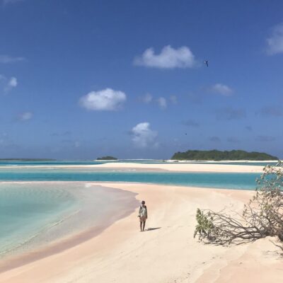 Carley Shelton on an expansaive beach on unihabited Rongerik Atoll. Photo: Grant Gardner of S/V Viandante.