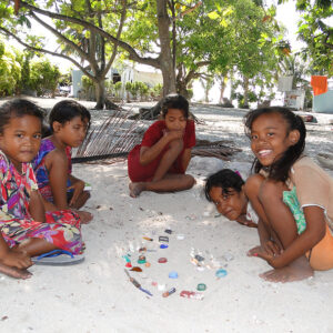 Girls play a make-believe game with found objects. Photo: Karen Earnshaw