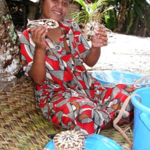 A young woman in Aur Atoll displays some of her handicrafts.