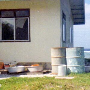 Rain catcher tanks outside a Majuro house in the 1970s.