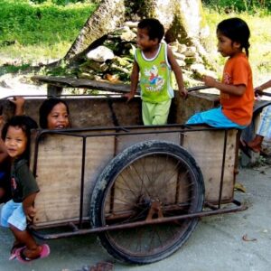 Kids play on a copra cart in Ebon.
