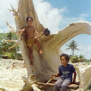 Who are these children on a some driftwood in the 1970s?