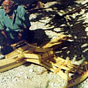 An old man makes a small canoe in Majuro.