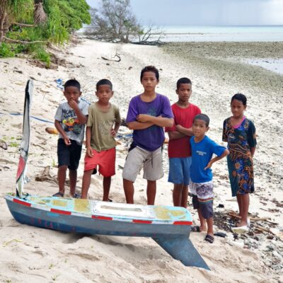 Children pose with the SV Philbert on the beach at Likunwor Island, which is where it landed on Mili Atoll. Photo: Mayor Joel Jitiam.