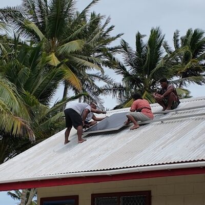 The solar panels for the health clinic are fixed into position.