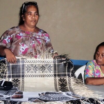 Expert weaver Patsy Jibas with Jibas Mary at a ceremony for the jaki-ed program on Nadrik. Photo: USP