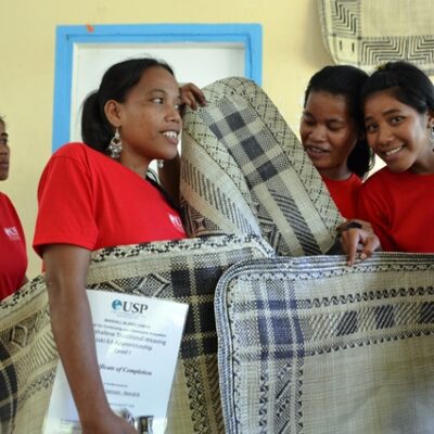 Proud apprentices with their jaki-ed (clothing mats) following the Namdrik weaving apprenticeship. Photo: USP