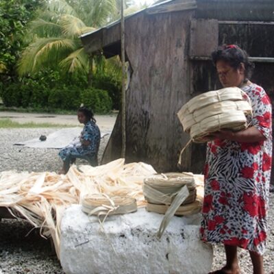 Namdrik's Neija Kinion lays dried pandanus leaves (maan) in the sun. Photo: USP