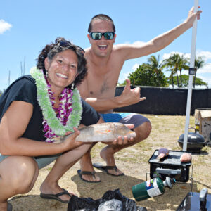 Natalie Nimmer with long-time friend Randy Sylvester at a 2018 beach party to celebrate Natalie's Doctorate of Education. Note the fish is from Wotje Atoll. Photo: Karen Earnshaw
