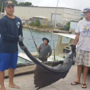 James Myazoe junior, James Myazoe (onWasabi) and Cary Evarts with their sailfish. Photo: Karen Earnshaw