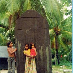 Children stand in front of the typhoon monument.