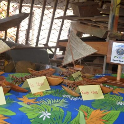Some of the miniature canoes and a plaque made by the trainees. Photo: Karen Earnshaw