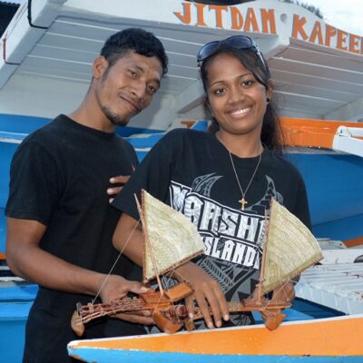 Trainees Bilton Ralpho and Naggie Kiluwe with the canoes they made. Photo: Karen Earnshaw