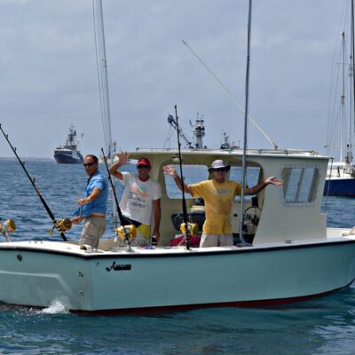 Fishing and dive boat Wasabi with happy crew.